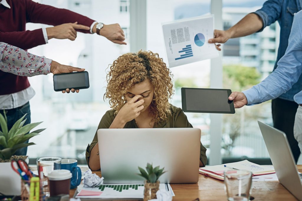 Shot of a young businesswoman looking stressed out in a demanding office environment